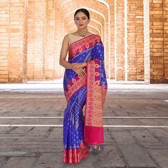 Introducing The Banarasi Malai Silk Sari - A Luxurious And Regal Piece That Is Sure To Turn Heads. This Stunning Sari Features A Beautiful Blue Silk Base, With A Stark Contrast Border In Hot Pink. The Unique Diamond Shaped Weave On The Pleats Is A Traditional Benarasi Weave. The Fall And Pico Are Also Done And The Blouse Is Stitched In Size Mentioned, Making It Perfect For Anyone Who Wants To Wear This Gorgeous Sari. Whether You're Attending A Formal Event Or Simply Want To Stand Out From The Cr Royal Blue Cutdana Dupatta, Royal Blue Banarasi Silk Traditional Wear With Zari Weaving, Blue Jamawar Traditional Wear For Navratri, Royal Blue Banarasi Silk Traditional Wear For Diwali, Blue Meenakari Traditional Wear For Transitional Season, Designer Blue Saree For Transitional Season, Semi-stitched Royal Blue Saree, Blue Designer Saree For Transitional Season, Blue Jamawar Traditional Wear For Diwali