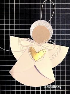 an ornament made out of paper with a gold heart on the front and back