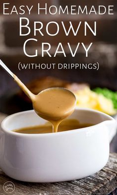 homemade brown gravy in a white bowl with a spoon full of gravy