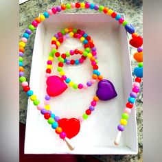 Beautifully Handcrafted Multicolored Stretchy Bracelet, Necklace And Head Band Set. Ships Asap! Makes A Great Gift For Girls Of All Ages! Multicolor Beaded Plastic Necklace, Cute Multicolor Plastic Necklaces, Playful Colorful Jewelry With Heart Beads, Plastic Heart Beads Jewelry For Gifts, Fun Multicolor Plastic Necklace, Rainbow Plastic Jewelry With Colorful Beads, Rainbow Colorful Beads Plastic Jewelry, Adjustable Purple Playful Necklace, Playful Adjustable Purple Necklace