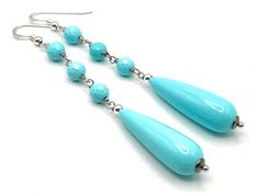 A pair of elegant earrings crafted with Italian 925 sterling silver, turquoise resin drops and faceted beads. LENGTH: 3.5 inches - 9 cm  WEIGTH: 5 gr.  Drop: 30 x 10 mm Faceted beads: 6 mm Matching necklace https://www.etsy.com/uk/listing/1269140421/turquoise-chunky-necklace-big-bold?click_key=67028e9a2bc8b891d8383a9f922ee51ef3037043%3A1269140421&click_sum=2d89f659&ref=shop_home_active_47&pro=1&frs=1&sts=1 MATERIALS: 925 Sterling Silver - Made in Italy Resin DELIVERY: All jewellery is shipped in Turquoise Teardrop Earrings With Faceted Beads, Turquoise Faceted Teardrop Earrings, Turquoise Teardrop Faceted Earrings, Faceted Turquoise Teardrop Earrings, Turquoise Faceted Bead Earrings, Turquoise Earrings With Faceted Beads, Turquoise Briolette Earrings For Gift, Turquoise Briolette Earrings As A Gift, Elegant Turquoise Faceted Earrings