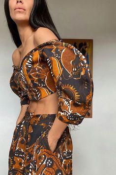 Off the shoulder top with a sweetheart neckline and sculptural sleeves in the mid century inspired, abstract floral Calaia print. Hidden elastic gusset so the sleeves stay in just the right spot. Fabric is 100% tencel. Ariana is 5'6", bust 33.5", waist 25", hip 35, and is wearing a size 0 Chic Retro Print Tops For Summer, Fitted One-shoulder Floral Print Tops, Fitted One Shoulder Floral Print Tops, Summer Fitted Blouse With Bold Print, Fitted Summer Blouse With Bold Print, Fitted Summer Blouse With Abstract Print, Chic Fitted Blouse With Bold Print, Bohemian Fitted Off-shoulder Top, Fitted Bohemian Off-shoulder Top For Spring