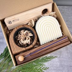 an open box containing soap, dish and brush