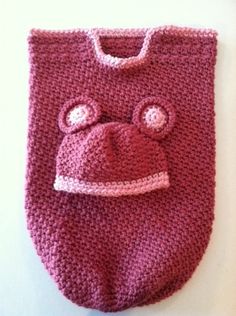 a crocheted bag with a pink hat on it's head and eyes