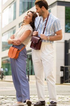 Mens summer outfit - white trousers and blue shirt with red leather crossbody travel bag - The Binocular Bag in Oxblood from The Cambridge Satchel Co. Crossbody Travel Bag, Find Your Match, Crossbody Bags For Travel, Cambridge Satchel Company