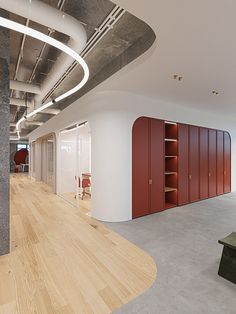 an empty room with wooden floors and red lockers on the wall next to it