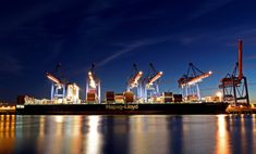 a large cargo ship is docked at night