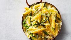 pasta with asparagus and parmesan cheese in a skillet on a table