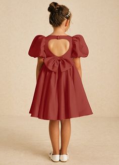 Muffin showcases a charming A-line shape in matte satin, featuring a stylish square neckline and a convenient zipper closure adorned with covered buttons. Finished with lovely bows, this dress is a delightful blend of elegance and whimsy for any young bridesmaid. Satin A-line Dress With Bow, Party Dress With Square Neck In Solid Color, Chic Dress With Bow Detail, Square Neck Satin Dress With Ruffles, Satin Square Neck Dress With Ruffles, Puff Sleeve Dress With Bow For Party, Fitted Dress With Detachable Bow And Sweetheart Neckline, Fitted Dress With Sweetheart Neckline And Satin Bow, Fitted Dress With Satin Bow And Sweetheart Neckline