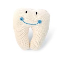 a white tooth with blue eyes and a smile on it's face is shown in front of a white background