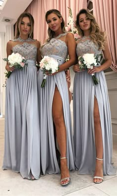 three bridesmaid posing for the camera with their dresses in grey and white colors