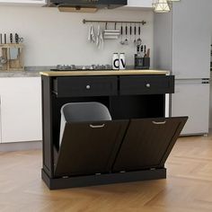 a kitchen with an island that has two trash cans in it and some utensils hanging from the ceiling