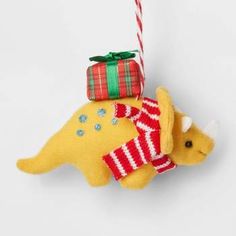 a yellow dinosaur ornament hanging from a string