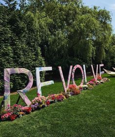 the word revolve is made out of flowers and letters that spell it's love