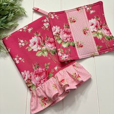 two pieces of pink fabric with flowers on them