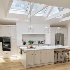 a kitchen with an island and skylights above it