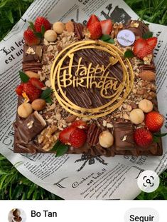 an image of a happy birthday cake with strawberries and nuts