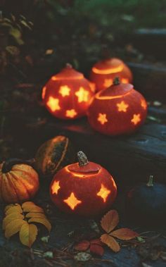 some pumpkins that have been carved to look like stars