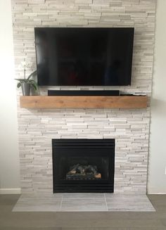 a flat screen tv mounted above a fireplace