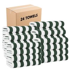 green and white striped towels are stacked next to a cardboard box