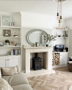 a living room filled with furniture and a fire place in front of a wall mounted mirror