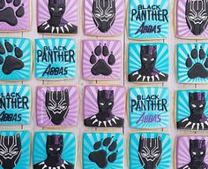 decorated cookies with black panther logos and paw prints