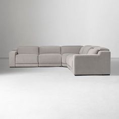 a large sectional couch sitting on top of a white floor