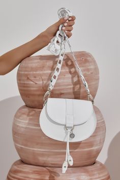 Ultra-chic mini white purse, handmade of fine quality leather. Clio design features our signature chain shoulder strap with metallic hardware. Carry this boho-style white saddle bag with you from day to evening when you only need the essentials. It comes in 4 colors: White, camel (waxed tan), black and black & white. ●Size: Height 16cm(6.3 inches) - Width 20.5(8.1 inches) - Depth 4.5cm(1.8inches) ●Detachable strap: 106cm (41.7inches) ●Magnetic snap closer ●Without lining Greek Chic Handmades boho style leather bags are delivered in a luxury box with dust bag included. Discover the whole collection with our unique leather bags: www.etsy.com/shop/GreekChicHandmades?ref=seller-platform-mcnav&section_id=15827194 Back to the shop: www.etsy.com/shop/GreekChicHandmades SHIPPING Every bag is handm Luxury Box Bag With Detachable Strap For Shopping, Elegant White Saddle Bag With Detachable Strap, White Crossbody Shoulder Bag With Silver-tone Hardware, White Leather Crossbody Saddle Bag, White Leather Shoulder Saddle Bag, Modern White Shoulder Bag With Metal Hardware, Chic White Leather Saddle Bag, Luxury White Saddle Shoulder Bag, White Crossbody Bag With Metal Hardware