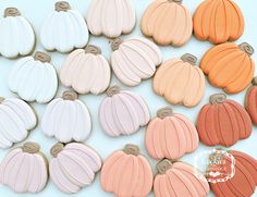 there are many different colors of cookies in the shape of pumpkins