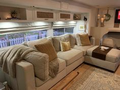 a living room filled with furniture and a flat screen tv mounted to the side of a wall