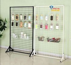 there is a display with cell phones on the wall and baskets in front of it