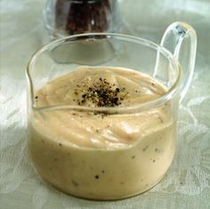 a glass pitcher filled with food on top of a table