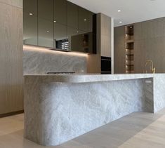 a modern kitchen with marble counter tops and cabinets