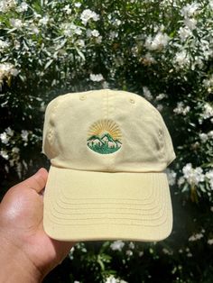 This Sunset Adventure Mountain Embroidered Dad cap / Baseball hat is perfect to show off your love for nature! This hat is perfect for hiking days as well as being fashionable. Our hats are not gender specific, therefore anyone's to enjoy these caps! Specs: - 100% bio-washed chino twill - Unstructured, six-panel, low-profile - Pre-curved visor - Self-fabric tri-glide buckle closure *Processing time is 1-3 Weeks. Most Orders are processed within the first week, the extra weeks allow for mechanica Cheap Embroidered Snapback Baseball Cap, Affordable Embroidered Baseball Cap, Embroidery On Hats Baseball Caps, Outdoor Embroidered Trucker Baseball Cap, Embroidered Trucker Hat For Outdoor, Embroidered Outdoor Baseball Cap, Embroidered Snapback Baseball Cap For Outdoor, Cotton Snapback Hat For Outdoor Activities, Outdoor Snapback Hat With Embroidered Logo