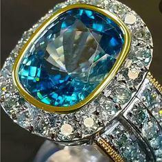 Blue Topaz Statement Two-Tone With Three Side Rows And Hallow Zircon On Cigar Band Cocktail Ring All My Rings I Am Able To Sell At A Affordable Price Because I Believe Everyone Deserves A Little Bling This Is An Exceptional Piece Blue Topaz Jewelry For Formal Occasions, Blue Topaz Ring With Cubic Zirconia Gemstone Accents, Blue Cubic Zirconia Jewelry With Gemstone Accents, Blue Aquamarine Jewelry With Center Stone, Blue Aquamarine Fine Jewelry, Blue Topaz Jewelry With Diamond Accents, Blue Topaz Jewelry With Accent Stones, Light Blue Topaz Jewelry With Center Stone, Light Blue Aquamarine Jewelry With Diamond Accents