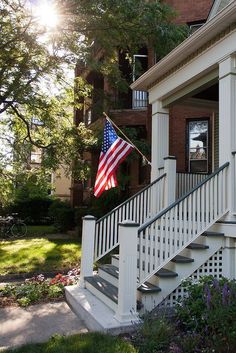 an american flag on the porch of a house