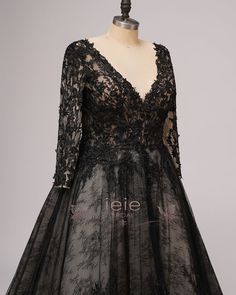 a black dress on a mannequin dummy with the word'leiie'printed on it