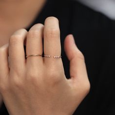 a woman's hand with a diamond ring on it