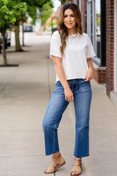 Never underestimate the power of a basic tee! This features a more cropped length making it ideal for all of your high-waisted shorts, pants, skirts, and jeans! Wear this as is or use as a base for all of your layering pieces! 100% Cotton Everyday Spring Cropped Bottoms, Spring Everyday Cropped Bottoms, Cropped Bottoms For Everyday Spring Wear, Casual Cropped Bottoms For Day Out, Cropped Bottoms With Pockets For Day Out, Cropped Medium Wash Bottoms For Day Out, Casual Cotton Crop Top With Pockets, Casual Stretch Bottoms With Cropped Hem, Cropped Cotton Bottoms For Day Out