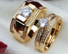 two gold wedding rings with diamonds on them