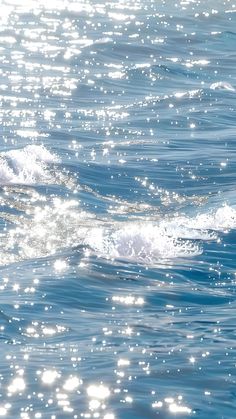 a man riding a wave on top of a surfboard in the middle of the ocean