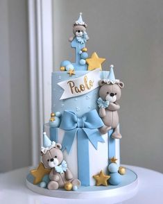 a baby shower cake with teddy bears and stars on the top is decorated in blue