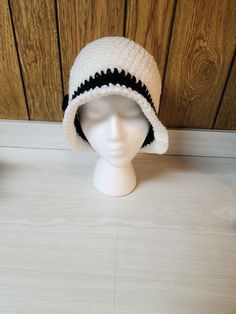 This hat is handmade by me. Acrylic yarn, in cute style. I can customize to your favorite color. Center accent may be different depending on availability. Ships in 2-3 weeks. I do not refund for buyers remorse. I do not ship internationally. Trendy White Brimmed Bucket Hat, Trendy White Winter Bucket Hat, Adjustable White Crochet Bucket Hat, White Adjustable Crochet Bucket Hat, Black Crochet Yarn Bucket Hat, Black Yarn Crochet Bucket Hat, White Short Brim Bucket Hat For Winter, White Winter Bucket Hat With Short Brim, Casual White Cloche Hat With Curved Brim