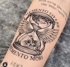 a tattoo with an hourglass and skull on the arm that says clemento vive eimento mori