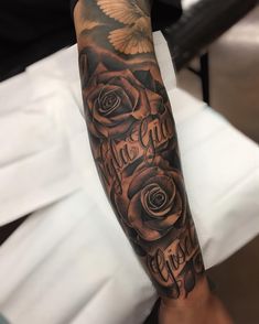 a man's arm with roses and the words love is greater than ever on it