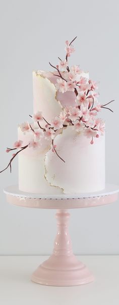 there is a white cake with pink flowers on it