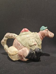 a ceramic figurine of a turtle with a hat on it's head