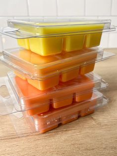 several plastic containers filled with food on top of a wooden table