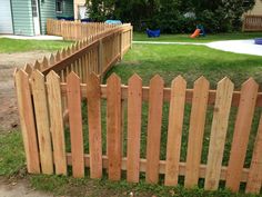 a wooden fence in front of a house