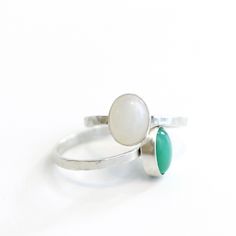 This exquisite ring features an oval gemstone that is bezel-set in either chrysoprase or moonstone. The Ascendant Gemstone Stacking Ring comes in two quality finishes - sterling silver or 14kt gold vermeil - both of which are perfect for any occasion. Chrysoprase is thought to promote feelings of optimism, joy, and happiness while also encouraging compassion, self-acceptance, and forgiveness. Moonstone is considered to be a stone of new beginnings and is believed to promote inner growth and stre Oval Chrysoprase Opal Ring For Gift, Green Oval Moonstone Promise Ring, Oval Green Moonstone Promise Ring, Oval Jade Ring With Natural Stones, Stackable Oval Emerald Ring In Silver, Oval Sterling Silver Stackable Emerald Ring, Green Oval Moonstone Ring In Sterling Silver, Oval Stackable Emerald Ring In Sterling Silver, Chrysoprase Emerald Ring With Oval Cabochon For Gift